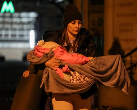 A woman carries her baby as she comes back from a shelter inside a metro station after a Russian missile and drone strike, amid Russia's attack on Ukraine, in Kyiv, Ukraine.