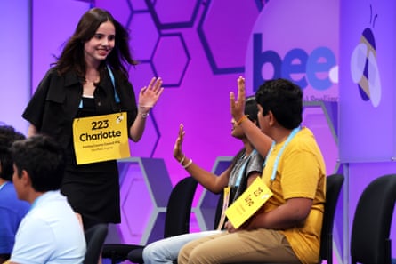 Speller Charlotte Walsh of Arlington, Virginia, high-fives other competitors after she correctly spelled her word during the final round of the 2023 Scripps National Spelling Bee in National Harbor, Maryland.