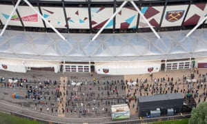 People queue outside an NHS Vaccination Clinic at West Ham’s London Stadium in Stratford, east London.