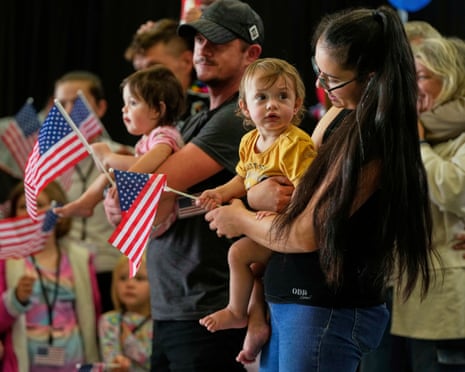 people hold US flags