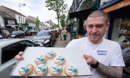 Graham McMorris holds a tray of Rory biscuits outside his bakery: they have a picture of the golfer printed on their icing.