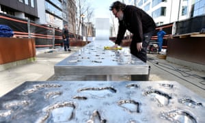 Artist Jean-Henri Compère puts the finishing touches to his sculpture