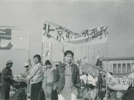 people stand under banners