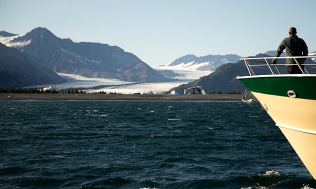 President Barack Obama looks at Bear Glacier, which has receded 1.8 miles in approximately 100 years, while on a boat tour to see the effects of global warming in Seward, Alaska.