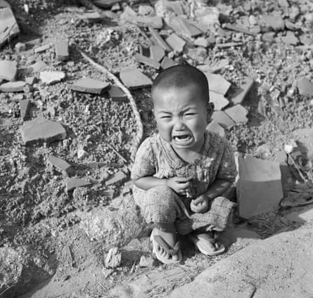 A toddler cries amid the rubble of Hiroshima