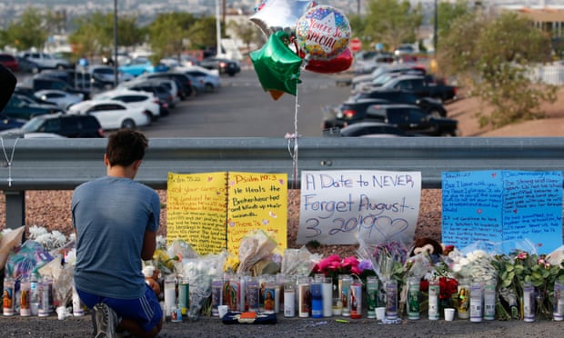 A young man prays at a makeshift memorial in El Paso, Texas.