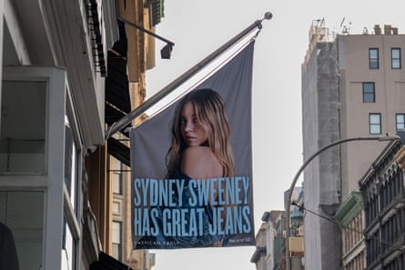Banner with Sydney Sweeney's face on it and the text 'Sydney Sweeney has great jeans' written on it hangs over a street in the US
