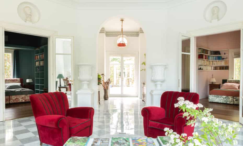 A pair of vermilion re-upholstered armchairs left by the original owners