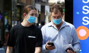 Pedestrians walk through Pitt Street Mall on 17 December in Sydney, Australia, as NSW prepares to reintroduce mask mandates for inside areas.