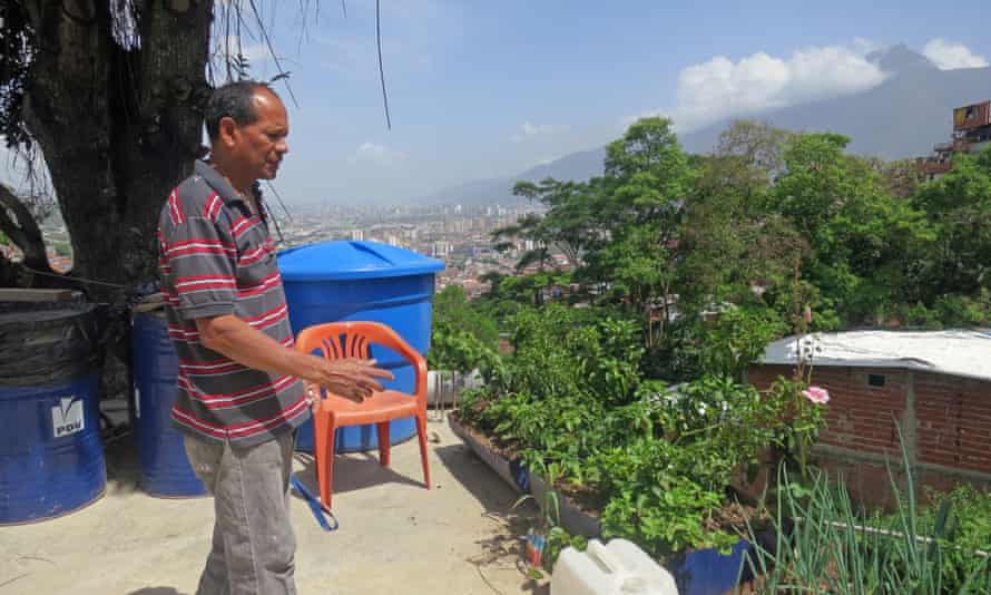Camacho shows off his rooftop vegetable and herb garden in Caracas.