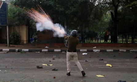 A police officer fires a teargas shell during the protest.