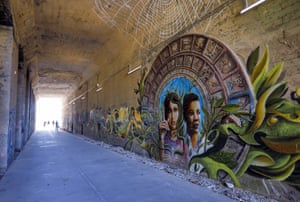 A mural entitled Coexistence by Miguel Dominguez painted inside a railroad tunnel in Atlanta, US