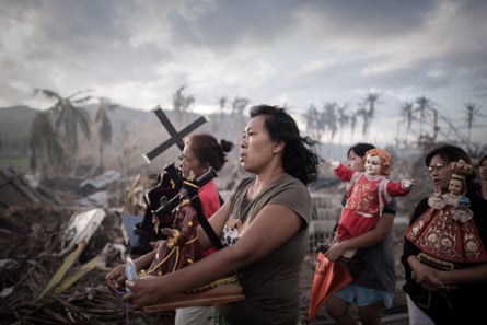 Survivors of the typhoon Haiyan march during a religious procession in Tolosa on the eastern Philippine island of Leyte, after it devastated the area. The United Nations estimates that 13 million people were affected, with about 1.9 million losing their homes. 18 November 2013.