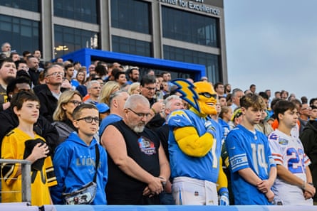 Fans stand for a moment of silence for the lives lost in New York City at the recent gunman attack before the Pro Football Hall of Fame NFL preseason game on Thursday.