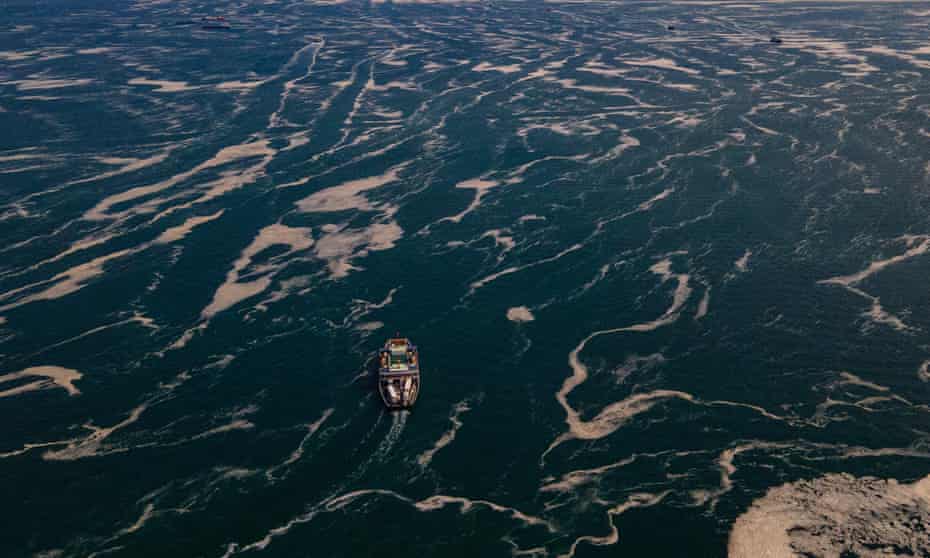 Boats sailing among the Marmara sea covered with sea snot, a jelly-like layer of slime that develops on the surface of the water due to the excessive proliferation of phytoplankton, gravely threatening the marine biome, in the Darica district of Kocaeli, Turkey. 