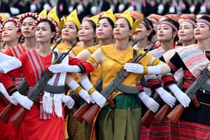 Women wearing national costumes and holding rifles