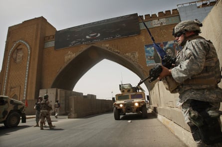 City watch … US army troops stand guard at a checkpoint in Baghdad, Iraq, in August 2007.