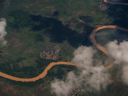 Aerial view of the Jubba river winding through green farmland near Kismayo, partly obscured by clouds