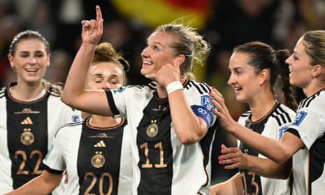 Germany's forward #11 Alexandra Popp (C) celebrates with teammates after scoring.