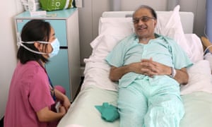 Patient Hitesh Patel talks to doctor Jasmine Gan on a Covid recovery ward at Wexham Park hospital near Slough in May
