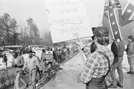 counter protesters hold confederate flags and pro-confederacy signs