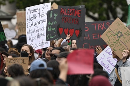 activists hold signs with slogans like ‘palestine forever’ and condemning genocide
