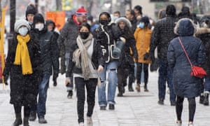 People wear masks as they walk down Montreal's Ste-Catherine Street, while Quebec prepares to limit home meetings to six people or two family bubbles.
