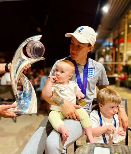 Lucy Bronze with her niece and nephew eating McDonald’s with the Euro 2022 trophy and medals