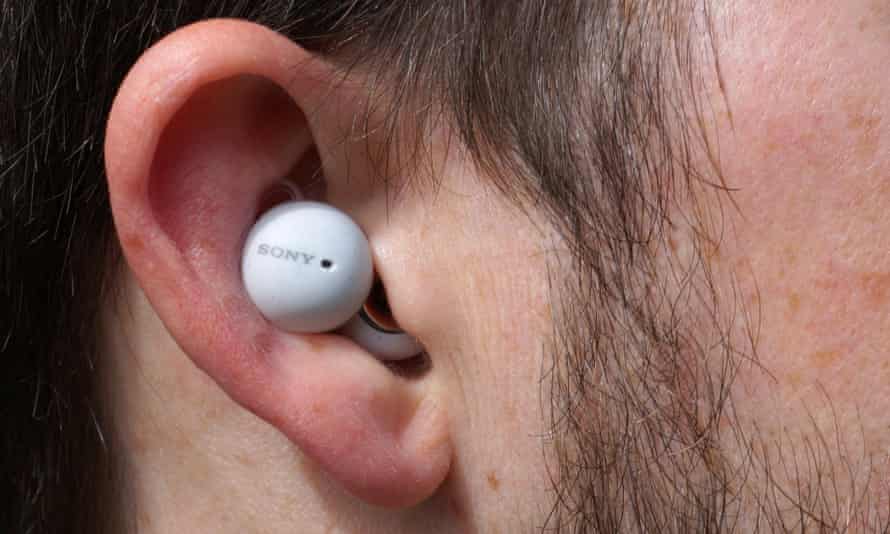 A LinkBud earbud shown inserted in an ear.