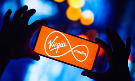 The Virgin Media logo is seen displayed on a smartphone.