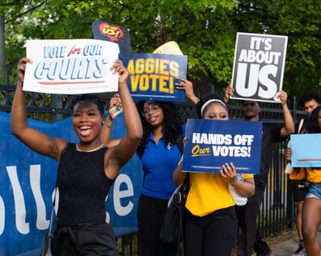 people hold signs outside
