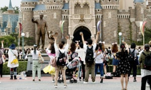 Visitors wave to Disney characters performing at Tokyo Disneyland in Urayasu, near Tokyo, Wednesday, 1 July 2020.