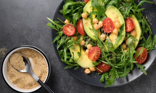 Green salad with avocado and nutritional yeast flakes