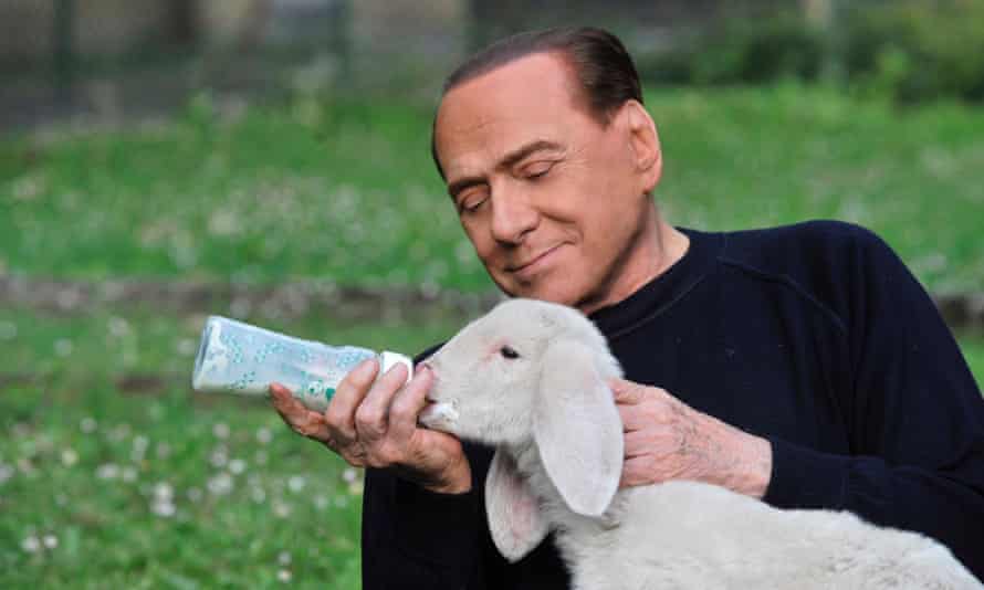 Berlusconi feeds a lamb with a baby bottle