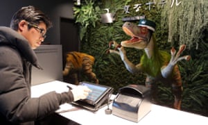 A dinosaur robot greets a guest at a reception of the newly opened Henn na Hotel” (