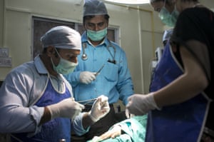 Dr Rakh supervises surgery on a woman’s hand