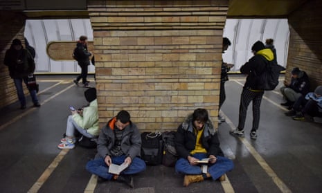 People shelter in a subway station during an air raid alert in Kyiv on Friday
