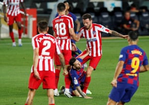 Saul Niguez takes down Barcelona’s Lionel Messi.