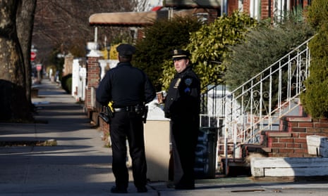 Police officers stand outside a home in Brooklyn on Monday. Public records showed that an A Ullah had been registered at an address in Kensington.