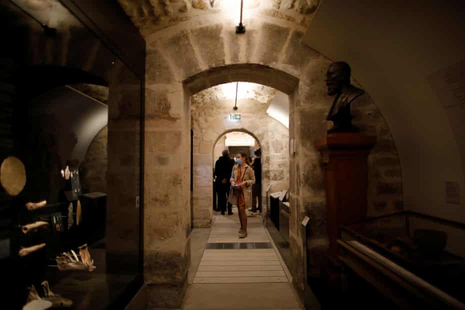 Journalists walk in the rooms devoted to Parisian history from the prehistoric period and Middle-Ages