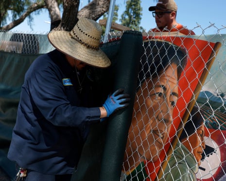 Man covers up mural of person