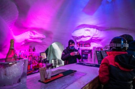 An igloo houses a bar where skiers can stop to order a drink and admire the ice sculptures carved into the walls.
