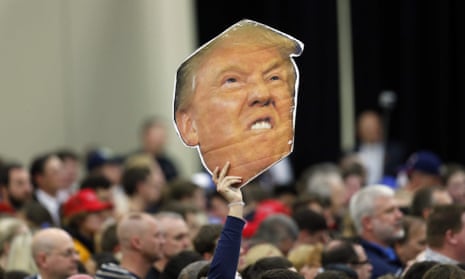A supporter holds a cut of Republican presidential hopeful Donald Trump at a rally