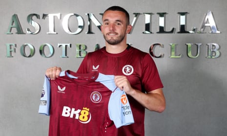 John McGinn with the 2023-24 Aston Villa home shirt, showing the BK8 logo