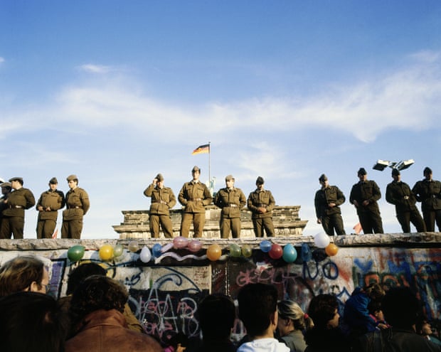 East Germans gather in front of the Berlin Wall in 1989