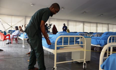 A technician measures the space between beds with a tape at a oronavirus isolation centre in Kano last month.