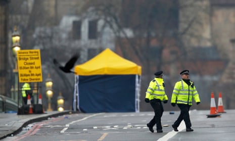 Police officers walk across Westminster Bridge the morning after an attack in March by a man in a car left five people dead and dozens injured.