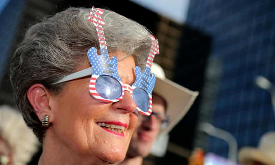 Barbara Hauser, of Texas, looks on as she waits to enter a Rock the Night kick off party on the sidelines of the Republican National Convention in Cleveland.