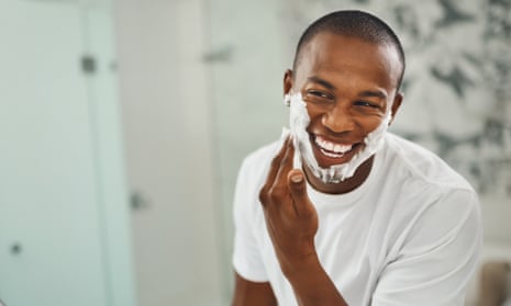 Man applying shaving cream to face