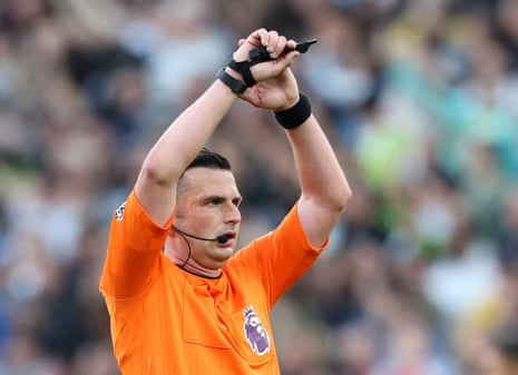 Michael Oliver leads today’s team of match officials at the London Stadium.